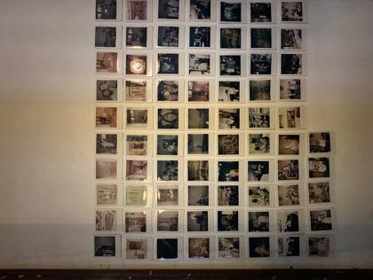 The wall of Polaroids at the front desk
